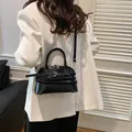 Vintage black glossy shell handbag with decorative buckles and detachable shoulder strap - Black