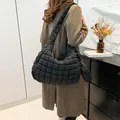 Black quilted cloud tote bag with matching round coin purse shown in a lifestyle setting - Shoulder Bag And Small Pouch Set / Black