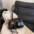 Glossy black faux leather multi-pocket shoulder bag with metallic heart charm and woven detail - Black With Rabbit Pendant