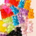 Macro shot of colorful resin gummy bear pendants with metal hooks for DIY jewelry making - Multicolor