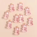 Detail of translucent pink resin bear pendants with gold metal rings for DIY jewelry - Pink