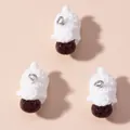 Detailed close-up of three cute white resin sheep pendants with silver metal loops - White