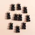 Top view of 10 shiny black resin bear charms with gold loops for DIY jewelry making - Black