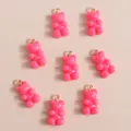 Close-up of pink resin bear charms with golden rings for DIY jewelry making - Rose Red