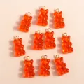 Group of 10 orange translucent resin gummy bear charms with golden metal loops - Red
