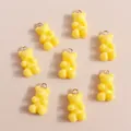 Detailed view of yellow gummy bear resin pendants with gold loops for DIY jewelry - Yellow