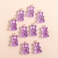 Close-up of translucent purple resin gummy bear charms with rose gold rings for DIY jewelry - Purple