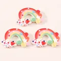 Detailed view of three resin rainbow cloud pendants with stars and hearts for DIY crafts - Red Heart Rainbow