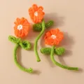 Three handmade knitted orange flowers with green stems for DIY accessories and crafts - Orange