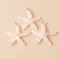 Detailed macro view of three pink resin starfish charms with iridescent sequins and metal loops - Nude Pink