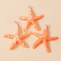 Three orange resin starfish pendants with glitter texture and silver rings for DIY jewelry - Orange
