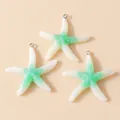 Detailed view of three resin starfish charms in white and green gradient with metal rings - White Green