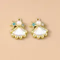 Detailed view of gold shell pendants with pearls and rhinestones for DIY jewelry - Gold White