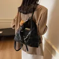 Vintage black faux leather tote bag with teddy bear charm and striped scarf detail - Black With Rabbit Pendant