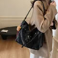 Black vintage tote bag with marble texture panels and a brown plush bear charm - Black With Rabbit Pendant