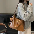 Minimalist caramel brown leather hobo bag with metal buckle and plush bear charm - 30*10*31 / Khaki