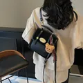 Classic black PU leather flap backpack for women featuring a cute brown plush bear charm - With Bear Pendant / Black