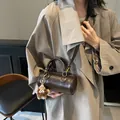 Brown cylinder crossbody bag with plush bear charm and fashion lettering detail - With Charm / Coffee