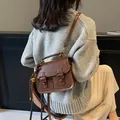 Vintage dark brown crossbody satchel bag with flap closure and tassel detail for women - Brown With Decorative Charm / Brown