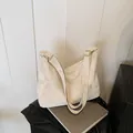 Elegant off-white faux leather tote bag with marble pattern and golden hardware - White