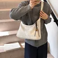 Chic white patent leather half-moon shoulder bag with woven strap and gold ball charm - White With Pendant
