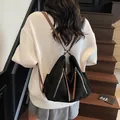 Zaino multiuso nero opaco minimalista con spalline marroni e cerniere metalliche - Nero