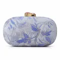 Detail of blue floral jacquard evening clutch with golden clasp and pink gemstone - Sapphire Blue