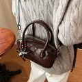 Dark coffee patent leather shoulder bag with a crossbody strap and beaded star charm - Brown