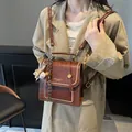 Vintage brown leather handbag with contrast stitching and decorative pendants - Coffee (No Pendant)