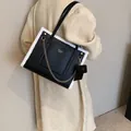Faux lamb wool tote bag in black and white featuring gold chain and small pouch - Black