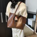 Dark brown faux leather tote bag with sheep pendant and decorative black and white strap - Large / Coffee with Pendant