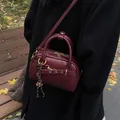 Vintage burgundy leather mini Boston bag with gold hardware and crossbody strap - With Pendant / Red