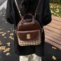 Vintage brown leather and plaid backpack with bear embroidery patch in outdoor setting - Brown