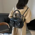 Chic black patent leather underarm bag with sweet bow pockets and silver hardware - Black