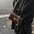 Dark brown retro leather flap shoulder bag with gold hardware and charm detail - Brown