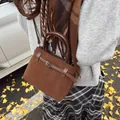 Mini brown matte leather tote bag worn by model in an autumn outdoor setting - Brown