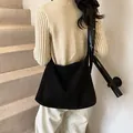 Minimalist large black suede tote bag with adjustable leather shoulder strap on model - Large Style / Black