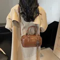 Retro dark brown leather Boston bag with bow charm, styled as a shoulder crossbody bag - With Pendant / Brown