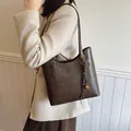 Minimalist dark brown leather tote bag for women with woven tassel and metal triangle detail - Standard Type / Brown