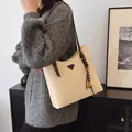 Beige faux leather tote bag with dark brown straps and metallic detail on knit sweater - Standard Type / Off-white