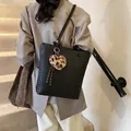 Black woven tote bag with a leopard plush heart charm on thin shoulder straps - Black With Rabbit Pendant