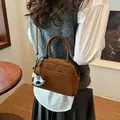 Brown vintage Boston shoulder bag with a cute rocking horse charm and matte finish - Tan