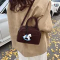 Brown faux suede Boston crossbody bag with horse pendant on autumn leaves backdrop - With Horse Charm (Coffee)