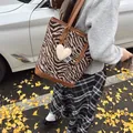 Brown zebra print tote bag with heart charm and leather strap in an autumn setting - Zebra Print