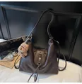 Close-up of deep brown PU tote with vintage texture, flower buckle, and cute dog charm - With Pendant / Coffee