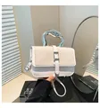 Detail of elegant two-tone bag with silver wavy metal handle and woven straw texture - Off White
