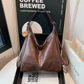 Retro dark brown frosted leather hobo bag with gold ring charm and sleek shoulder strap - Coffee With Charm