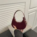 Deep burgundy crescent handbag in suede and leather finish with gold hardware details - Red