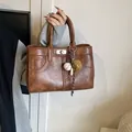 Vintage dark brown PU leather tote bag with metallic twist lock and baseball charm - Brown with Pendant