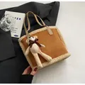 Detail of suede bucket tote with fleece trim and a cute crochet bear keychain accessory - Brown With Bear Charm / Brown